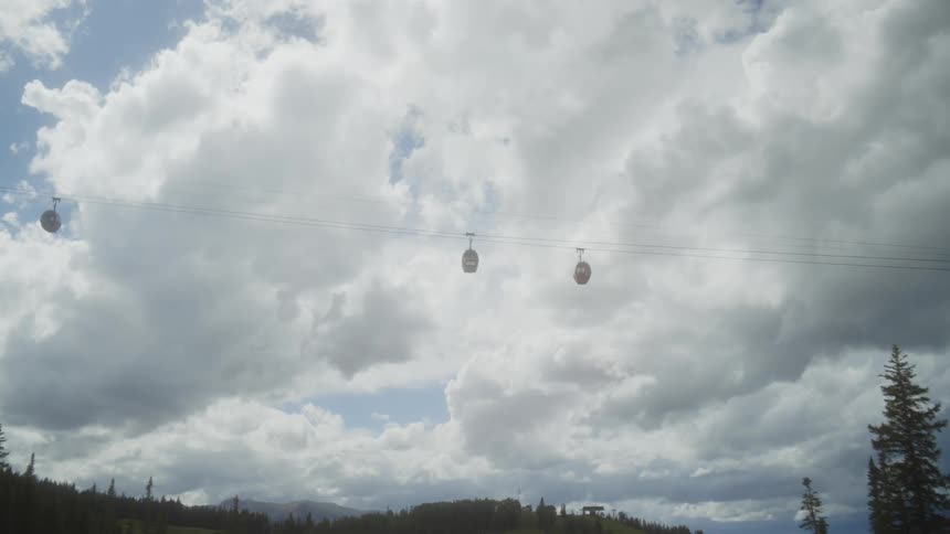 A sky lift is transporting people over the cables in the sky
