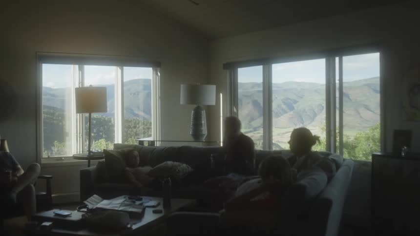 Friends sit in the living room talking