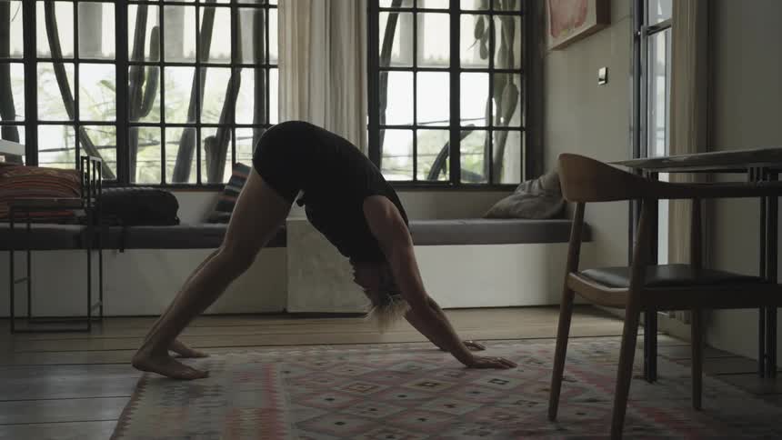 A man is doing yoga at home