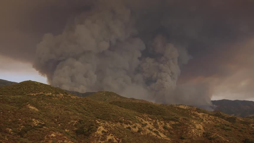 A huge amount of smoke is rising from the mountain