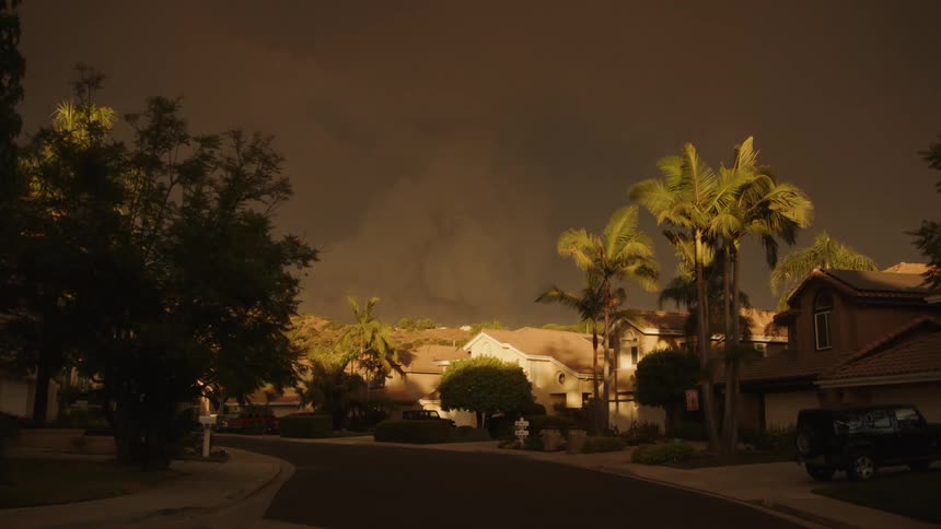 A car drives past the homes in the suburbs