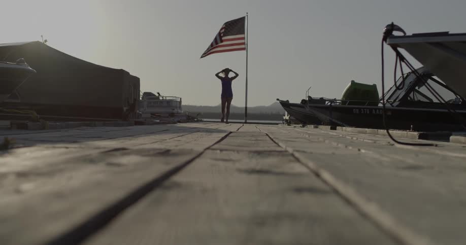 A woman walks along a pier