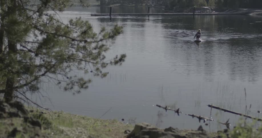 A person is rowing in the lake ahead