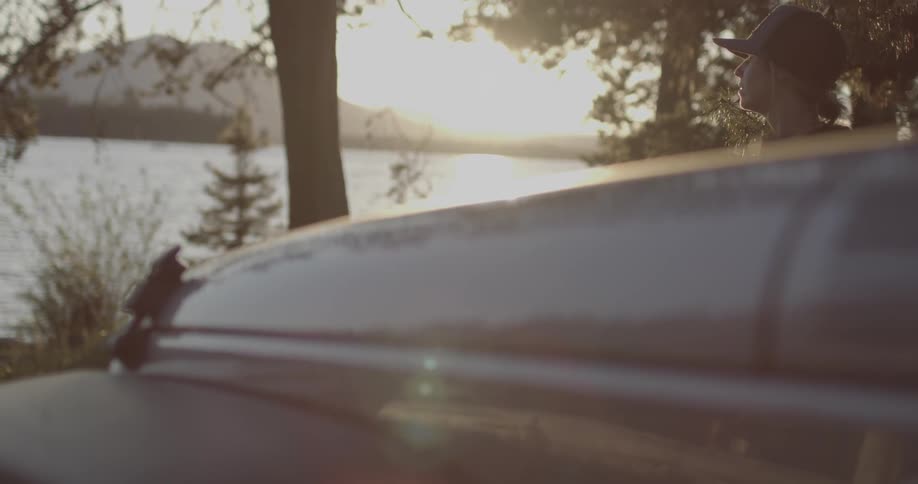 The sun shines over the lake ahead of this vehicle