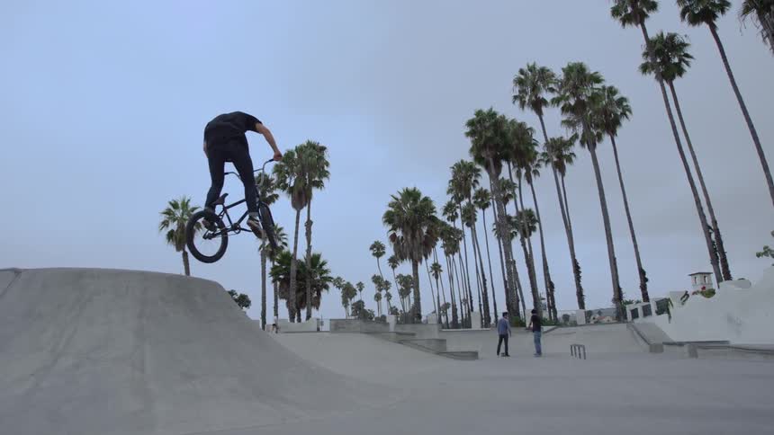 Man riding a bike in a bike park on a sunny day