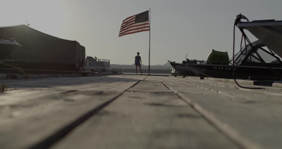 Person standing by an American flag