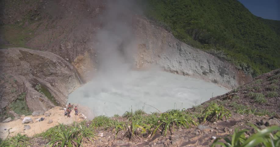 People watch steam rise from the water