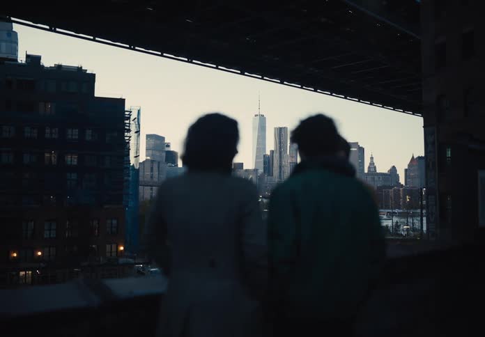 Group of three people talking in an outdoor area in a metropolis