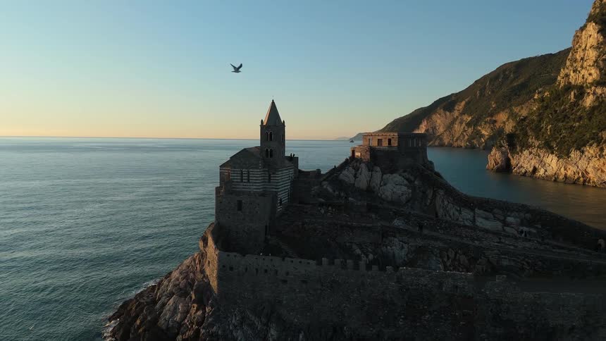 Aerial panorama of a classic medieval castle on a rocky coast by the sea