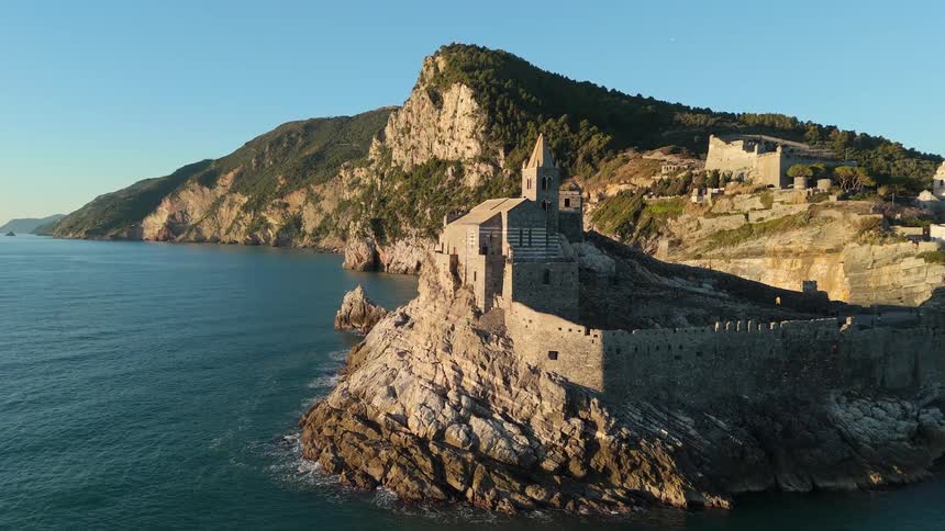 Birds fly by the monastery on the island
