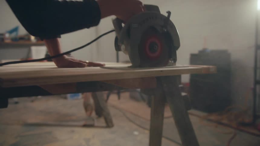 Carpenter cutting a sheet of wood
