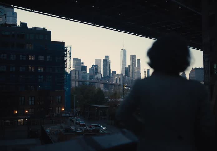 Three friends chatting on a sidewalk with a panoramic view of a metropolis