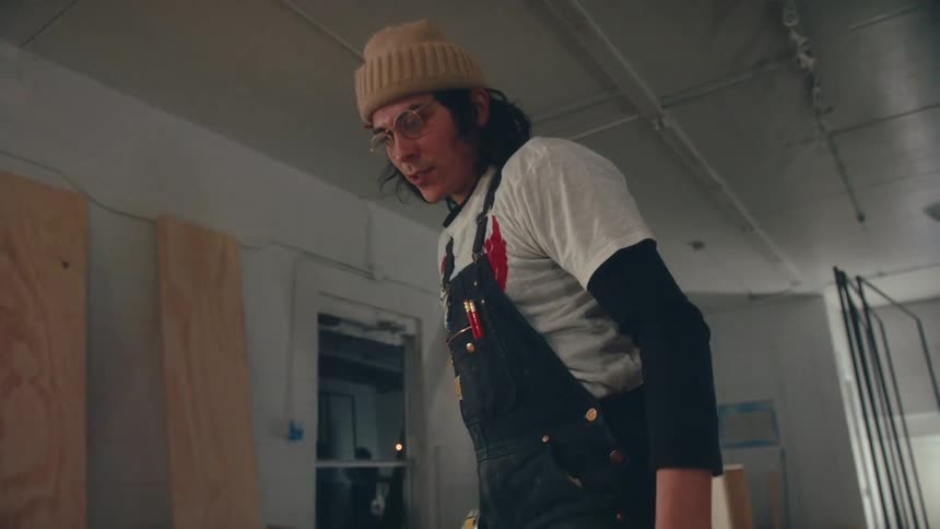 Carpenter with a machine sawing a sheet of wood