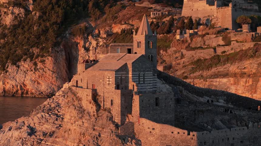 A stone church is on the hill of an island