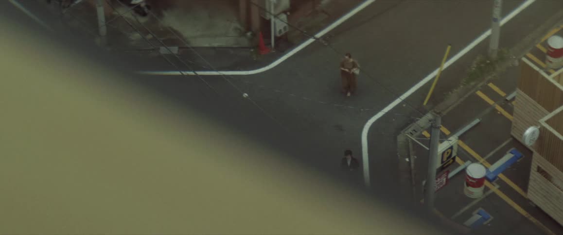 Pedestrians walking down an urban street in Tokyo neighborhood
