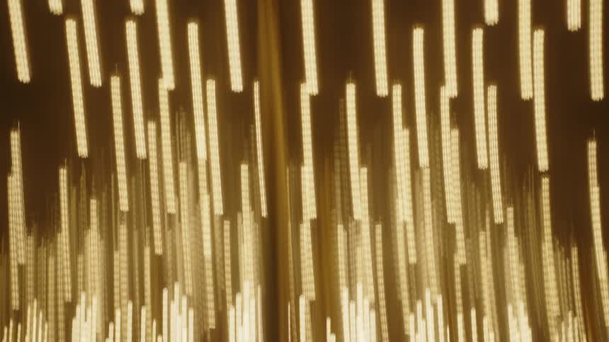 A camera whips around the lights of a carnival ride