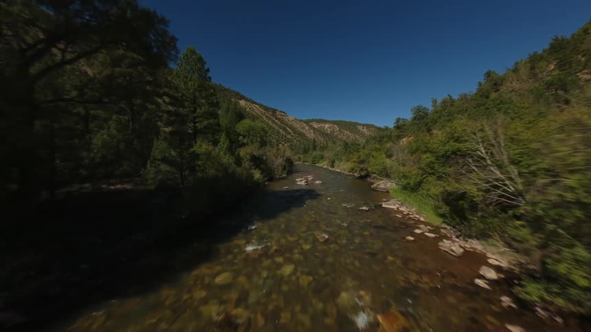 A river winds its way through a lush green valley