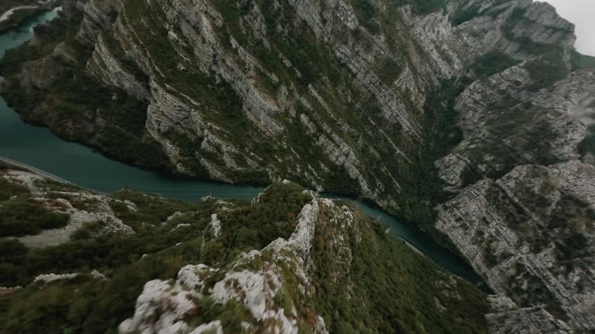 The river winds its way through the dramatic mountain valley