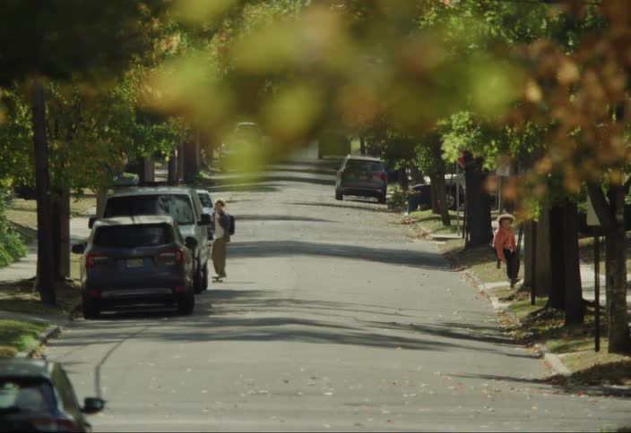 Two teenagers skateboarding down an urban street