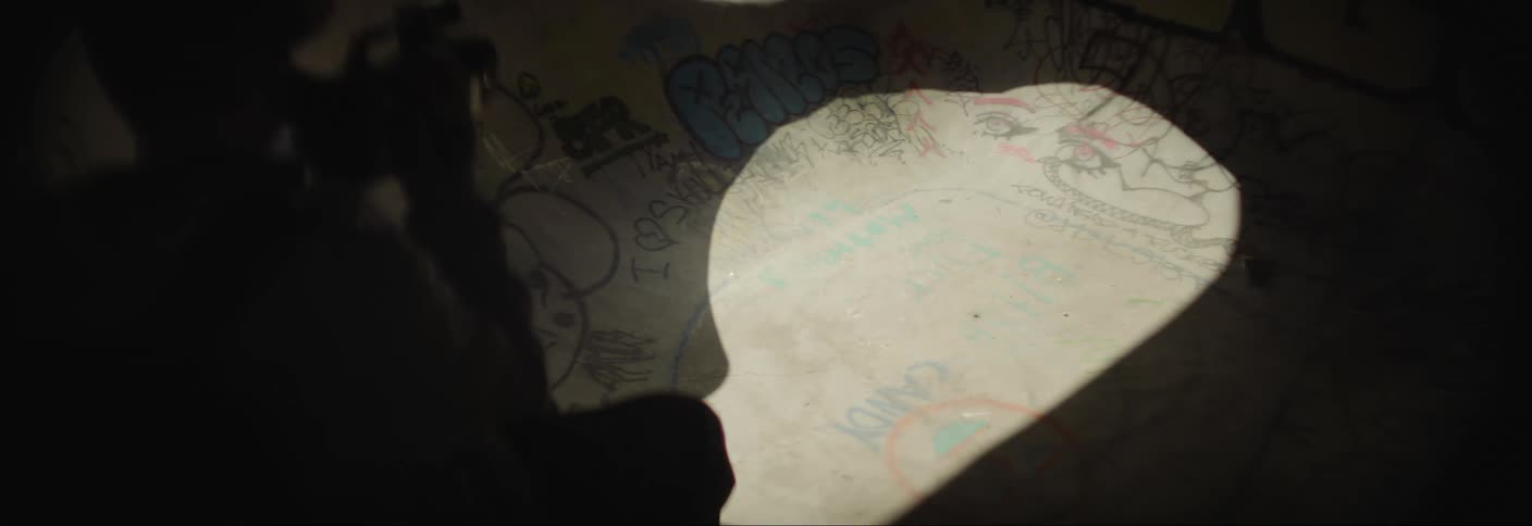 Person skateboarding on a track and another person filming with a camera