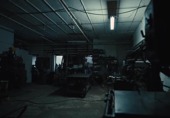 Man turning on the lights in a workshop
