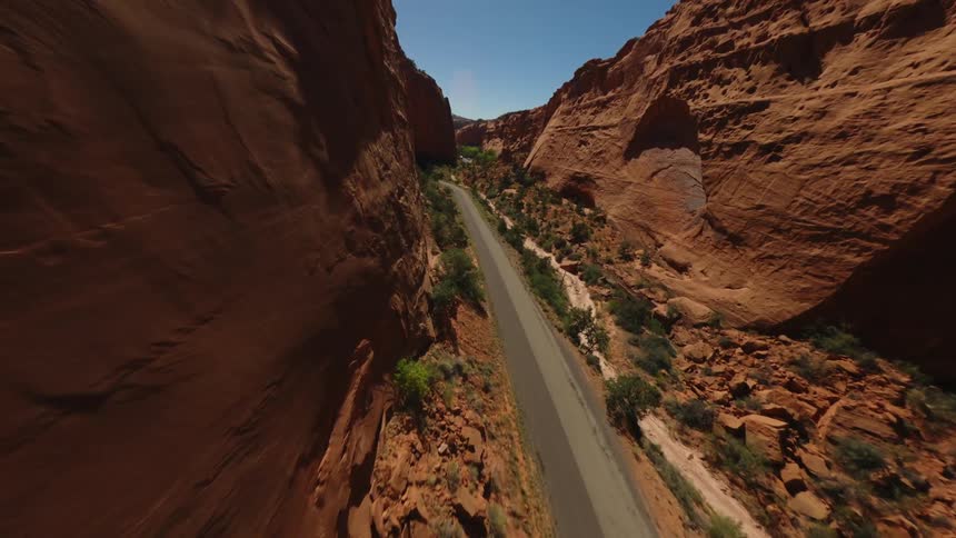 Aerial view of a long highway surrounded by canyons