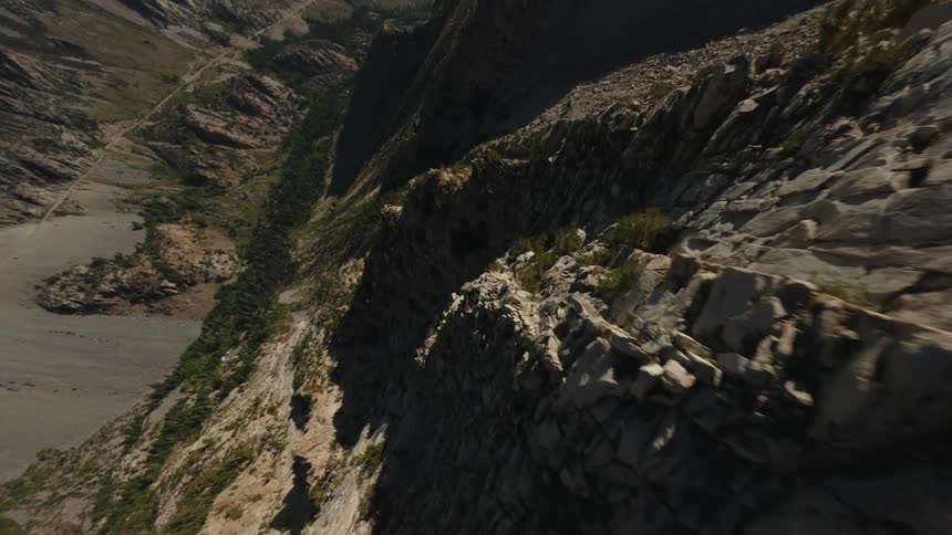 Aerial landscape of a long stretch of mountains with sparse vegetation