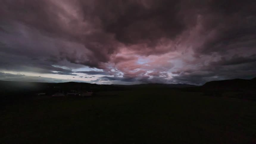 Aerial panorama of mountains silhouette with stormy sky