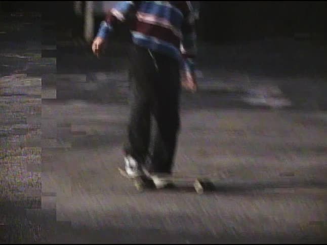 A teenager does a trick on his skateboard