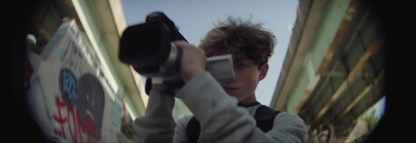 Teenager filming with a professional camera