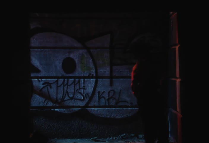 Two boys talking one of them goes out and walks down a dark hallway and the other walks back and forth