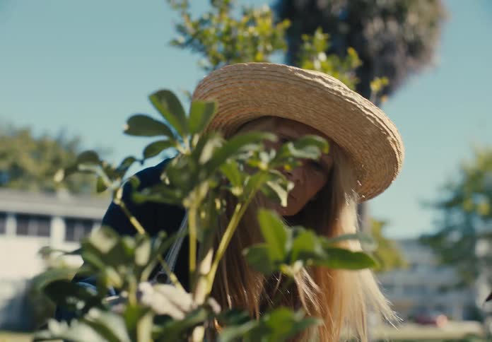 Woman crouching down gardening outdoors