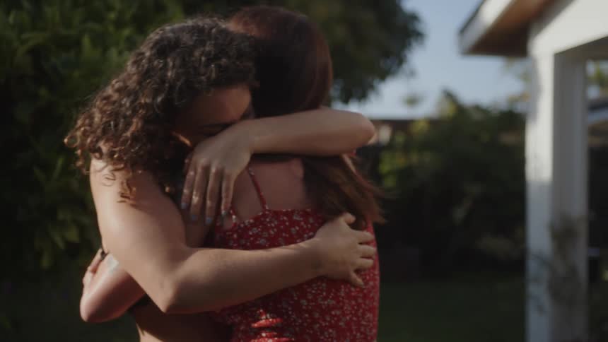 Two women hugging in an outdoor location