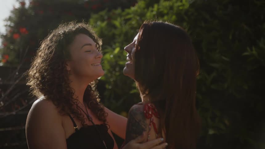 Two friends greet each other and hug