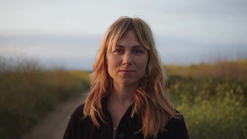 Portrait of a woman in a field smiling