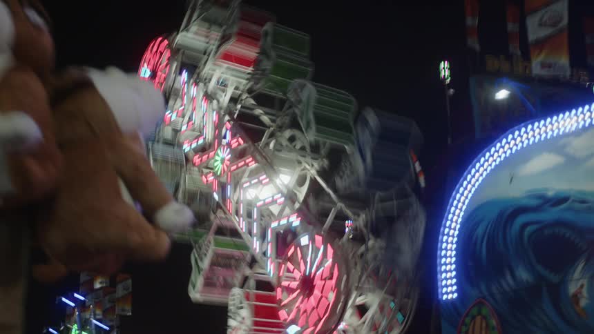 The carnival ride is spinning while being full of people