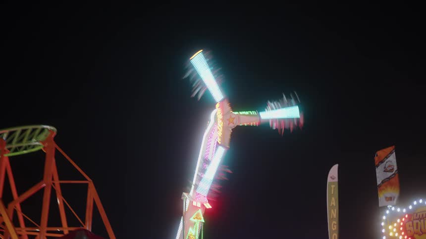 People swing in a circle on the carnival ride