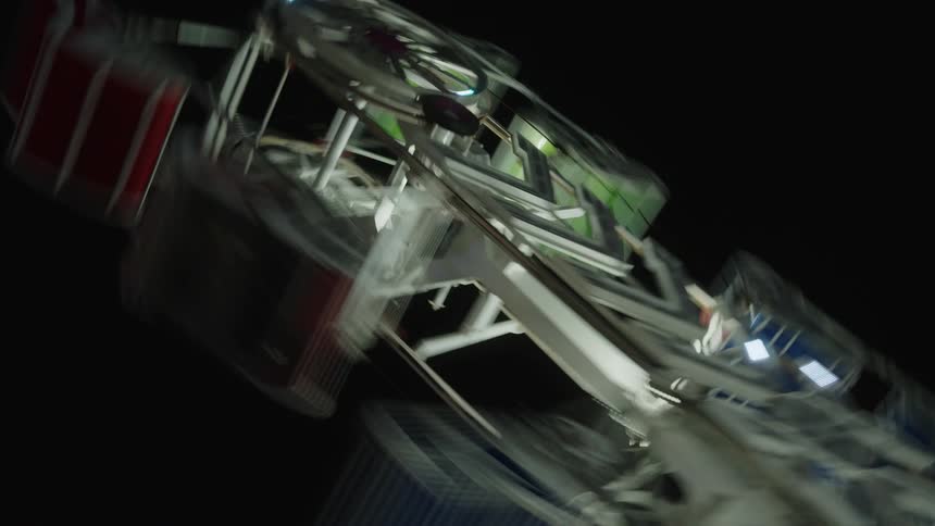 View from above of a ferris wheel with lights illuminated at night
