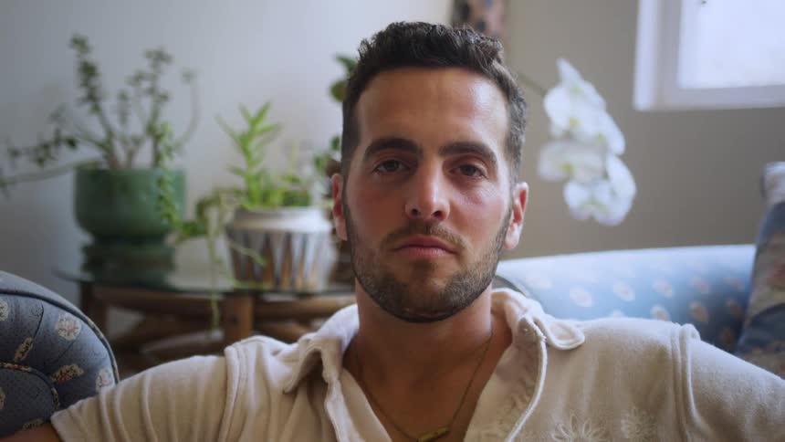 Portrait of a man sitting in the living room