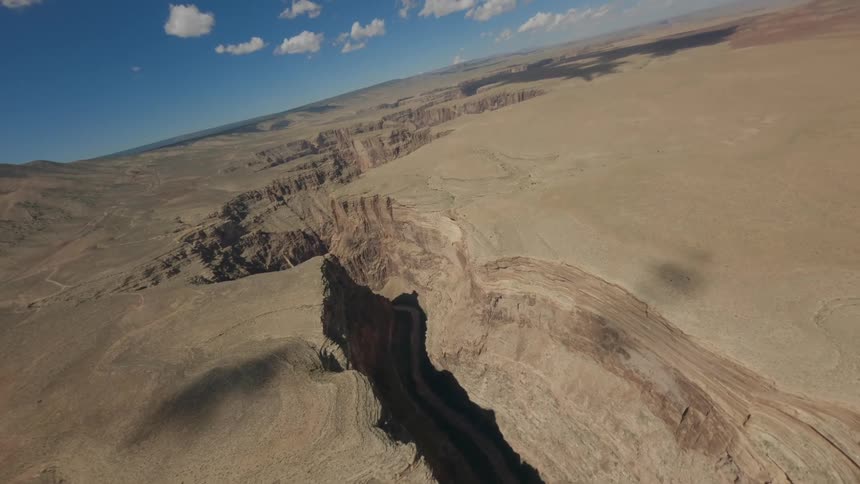 Aerial view of a mountain valley with crevasses