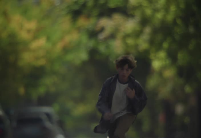 Two boys skateboarding down the street