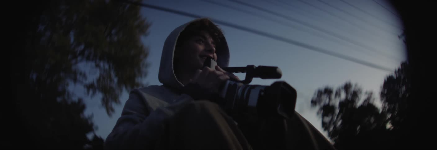 Boy using a professional camera outdoors