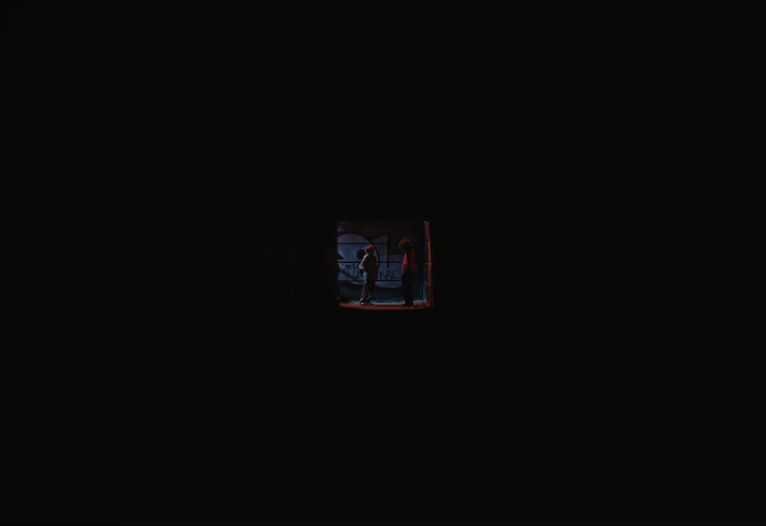 Two teenagers in a dark hallway