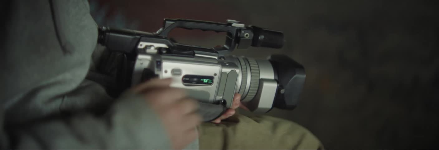 Pair of brothers setting up a professional video camera and starting to film