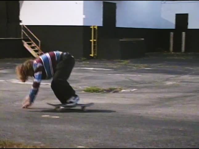 Teenage boy messing up a skateboard trick