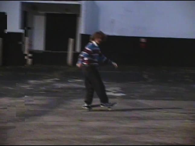 Boy doing tricks with a skateboard outdoors