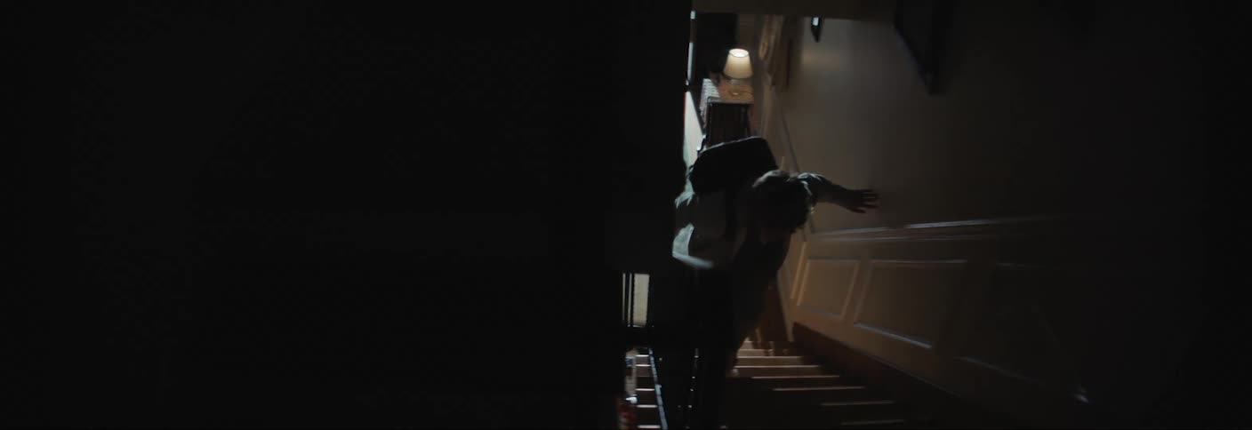 Youth arriving at home tries to climb a staircase quietly