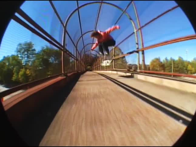 Boy tries a skateboarding trick in motion and ends up falling