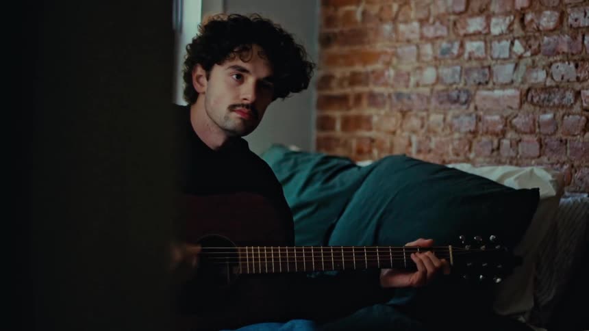 Man sitting playing guitar