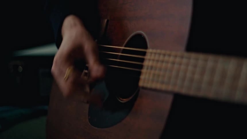 Close up of a person playing guitar